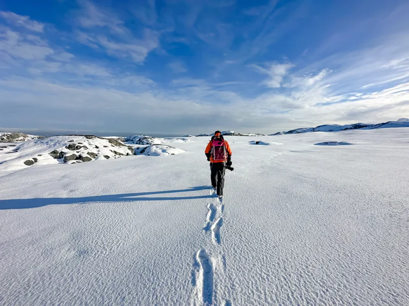Expedition Guide hiking across snow, Yalour Islands, Antarctica, David Stock @ Divergent Travelers