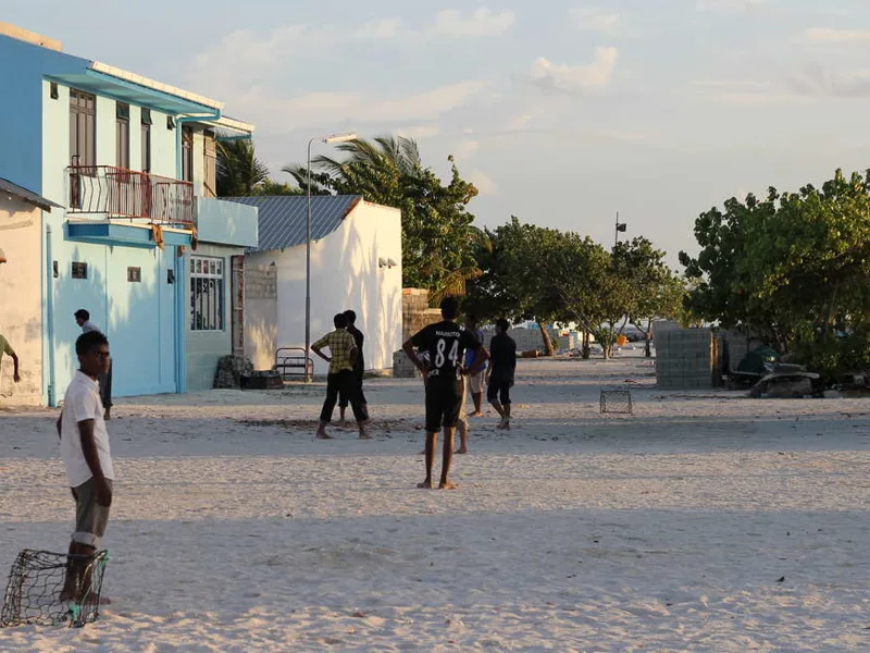 Boys playing football in small village