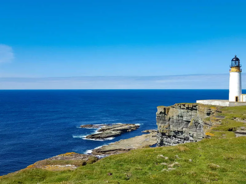 Lighthouse on Westray above steep cliffs of Noup Head