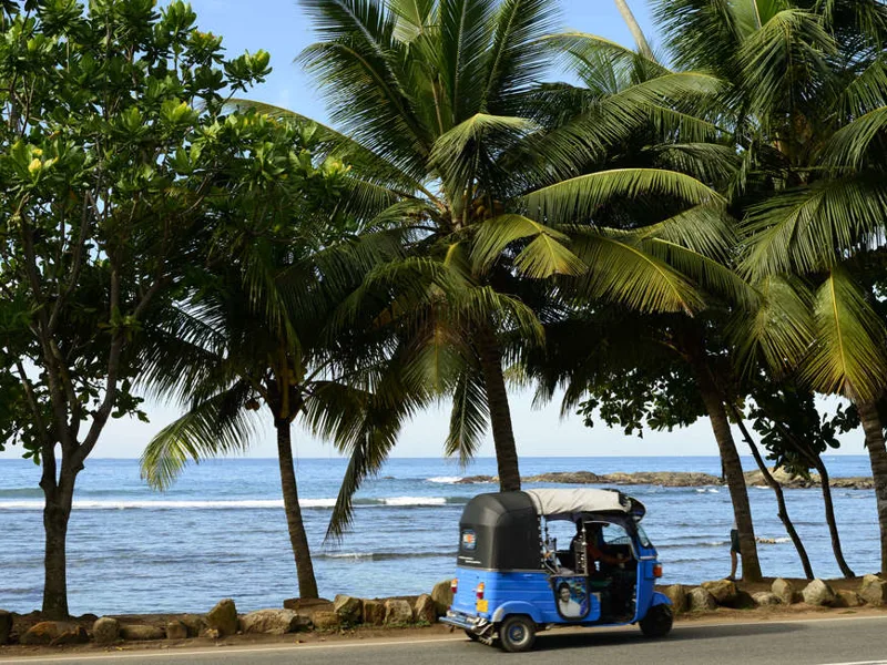 Tuk tuk drives past at Unawatuna